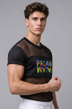 A man wearing a black short-sleeve mesh t-shirt with a colorful rainbow 'PANDA' graphic on the front, paired with white shorts, against a solid gray studio background.