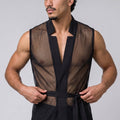 A muscular man wearing a black sheer mesh vest with a black waist tie, posing against a solid gray studio background.